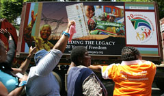 People cheering on the trucks of the 20 Years of Freedom exhibition as it drives by in Pretoria